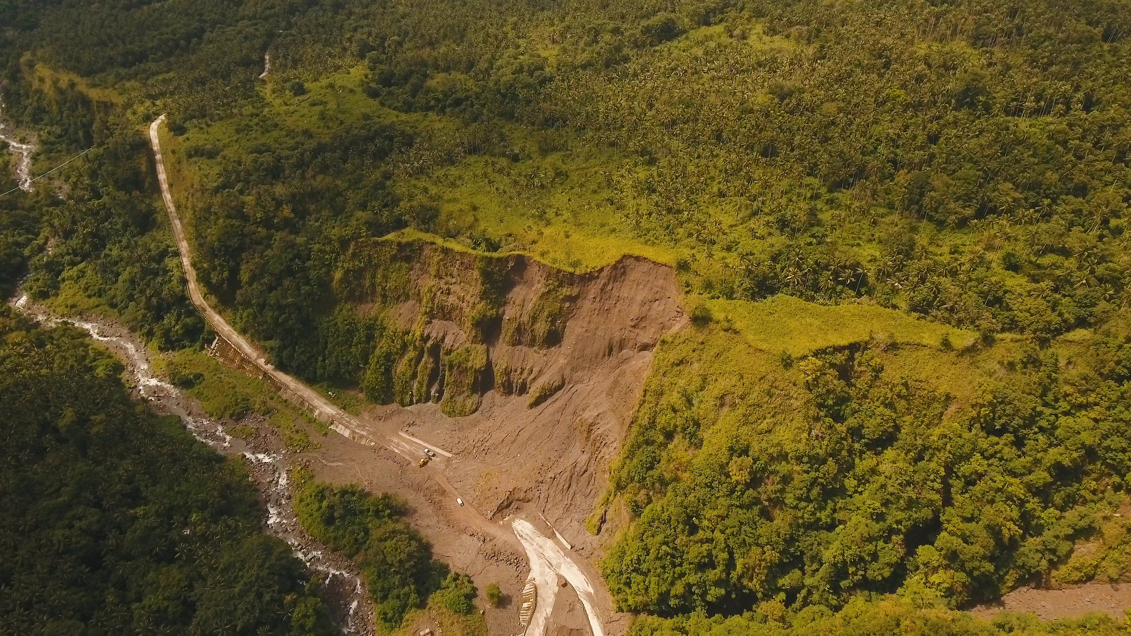 Lateral resistance of pipes and strip anchors buried in dense sand